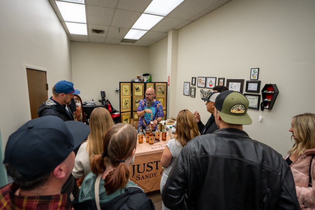 A group of people watch a presentation from Just Rum -one of the Sip & Stroll stops. 