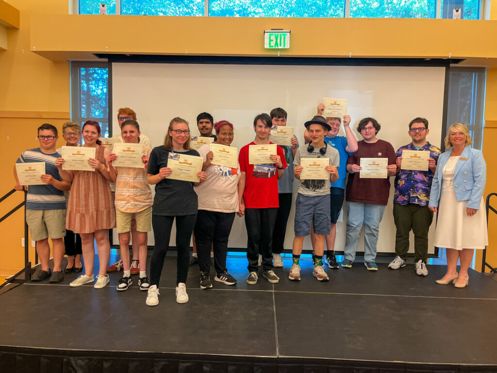 All of the summer youth employment program participants lined up on stage, receiving their diplomas from Oregon State Credit Union. 