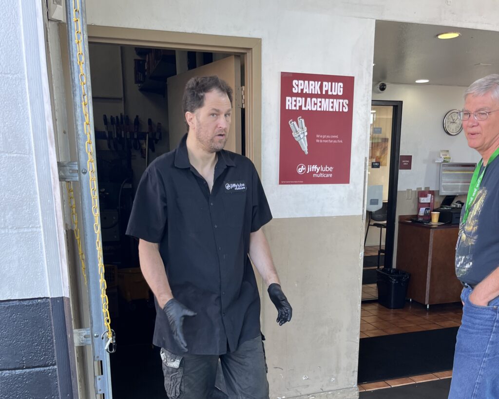 Chris working with his job coach at Jiffy Lube.