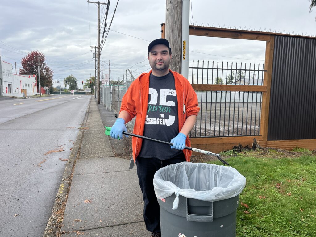Garten custodian cleans the outside of an AbilityOne location.