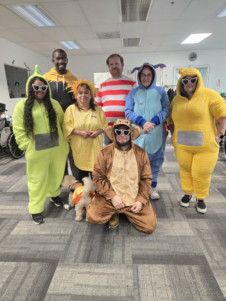 DayBreak employees and participants pose for a Halloween photo. 