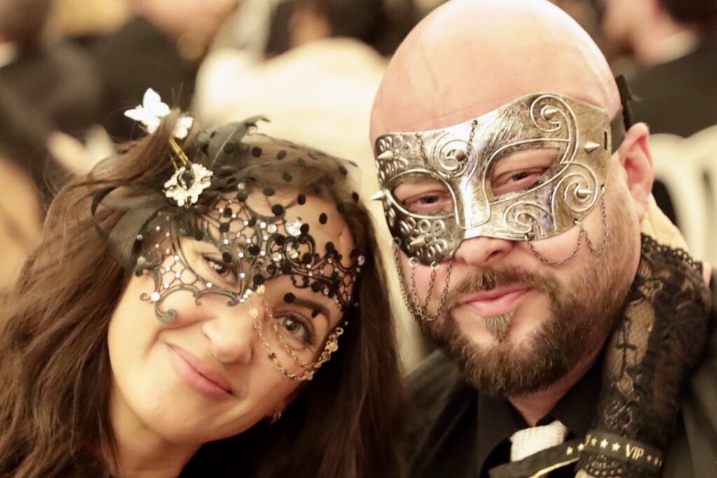 A couple poses with masks on at the Garten Gala. 