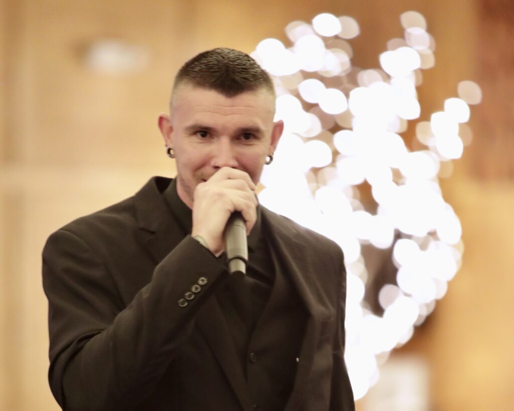 Emcee Jason Conrad hypes up the crowd at the Garten Gala. 