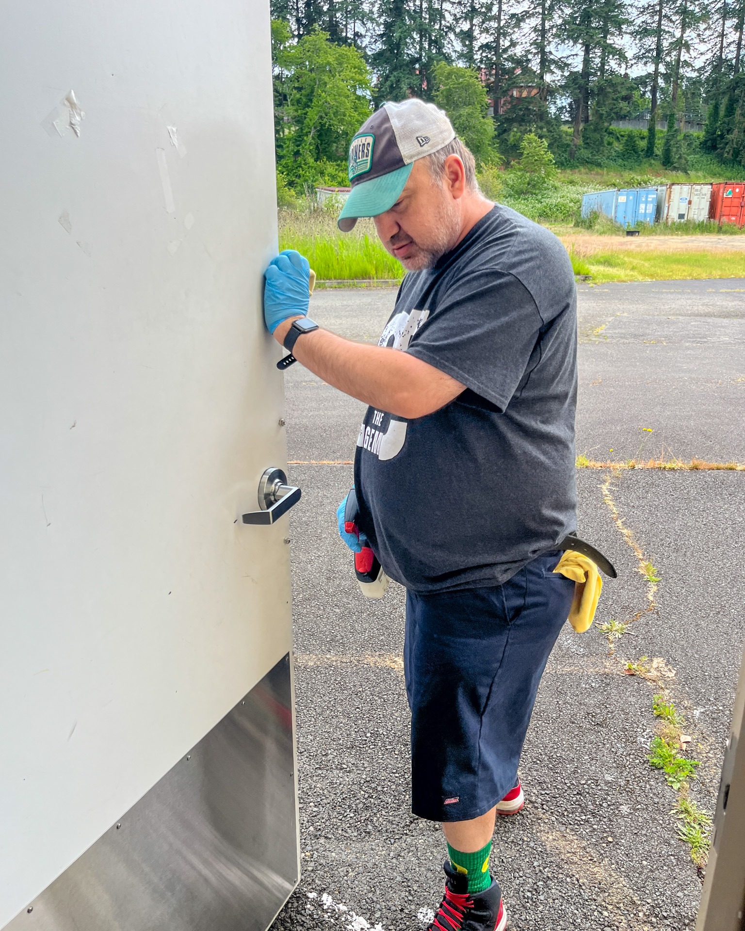 Custodian wiping down high-touch areas.