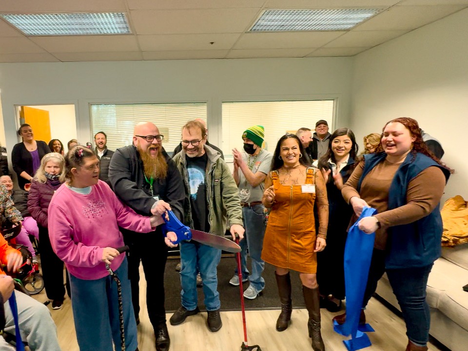DayBreak has a ribbon cutting with very large scissors. 