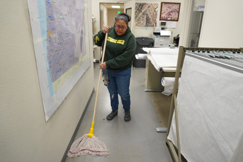 Carolyn mopping a floor as a custodian lead in salem, oregon. 