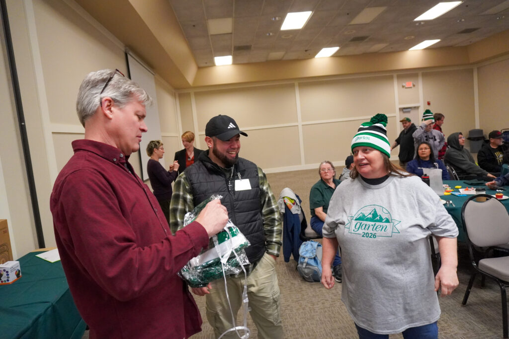 Garten CEO, Will Posegate, hands our Garten swag at the annual GEM event. 
